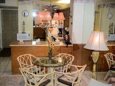 The dining room with Rattan style furnishings comfortably sits four people.
