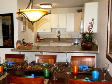 Kitchen with granite counters and dining table