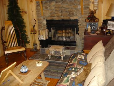 Living area with real woodburniing firreplace and futon.