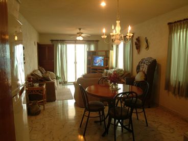 Livingroon and dining room opens to terrace and the swimming pool and ocean.