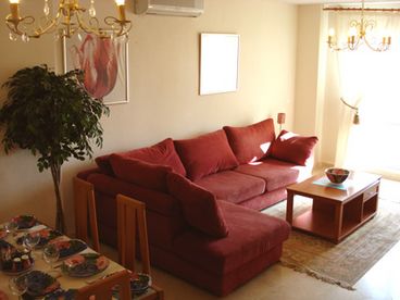 Lounge/Dining area: Large open-plan air-conditioned lounge/diner with patio doors leading to the sunny balcony. Furnished with large comfy sofa, coffee table, colour TV (English channels), DVD player and a portable stereo CD player. The dining area has a glass top dining table and 6 high backed chairs.