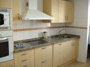 Kitchen : Large separate kitchen with breakfast bar area, granite work surfaces and equipped with ceramic hob, eye level oven and microwave, American style \\\'side by side\\\' fridge-freezer with ice maker, and a washing machine. A kettle, toaster, iron and ironing-board are also provided.