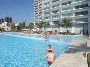 Largest infinity pool in Puerto Vallarta. Few steps from the beach with Palapas and volley ball net. Pool area also has a hot tub and lap pool. 