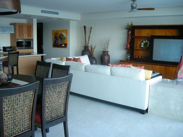 Large living/ dining and kitchen area overlooking the ocean. 