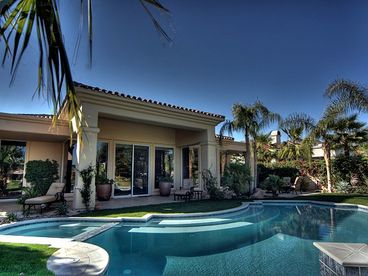 Stunning custom designed pool is solar heated and features bar seating, Jacuzzi and soothing water elements, creating a magical desert paradise.