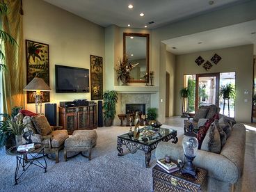 Exquisitely furnished with elegant yet cozy seating. Spectacular and picturesque floor to ceiling windows enhance pool and golf course views. Our �wow� living room features full bar with refrigerator, bar seating, 58� state of the art flat screen plasma HD TV with Blue Ray and state of the art audio equipment. A large gas fireplace and designer touches are set in a spacious environment highlighted by 30� soaring ceilings.