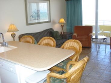 Immaculate living room with all tile floors and corian counter tops.