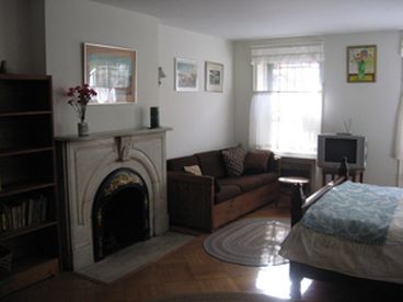 Spacious suite with decorative marble fireplace, parquet floors, high ceilings, filled with morning sunshine