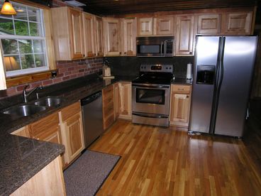 Gourmet kitchen with granite counters, stainless appliances and fully stocked.