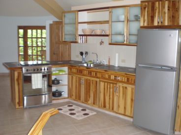 Kitchen w/full size refrigerator, stove, and microwave