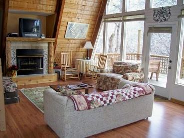 Living area with gas log fireplace, great views, and access to deck.