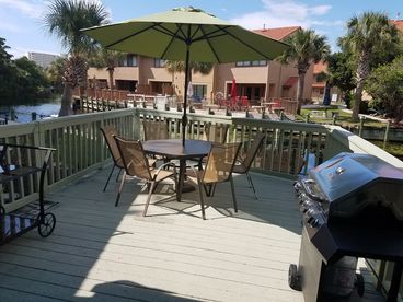 Back deck overlooking canal with patio furniture & grill.  You can fish, cookout, or just relax and enjoy the view!