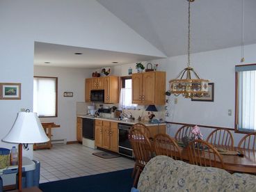 View of kitchen from the living room.  All modern inside, high ceiling, great view of the lake.