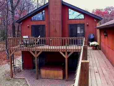Deck on right connects to the garage.  Hot tub is in the center.