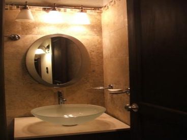 Modern bathroom with cream travertine.