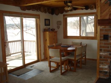 Dining area w/ patio door facing lake