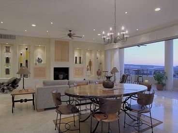The adjacent private rooftop deck has a long dining table, and outdoor kitchen, BBQ as well. 