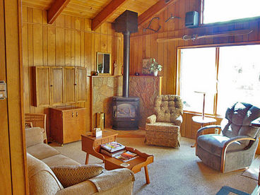 Living room with pitched beam ceiling, gas fireplace, swivel rockers and recliners, wide screen HDTV, wireless high speed internet, stereo, DVD player and iPod hookup to stereo spakers