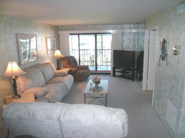Comfy, dreamy living room where every seat reclines in front of the big screen television.