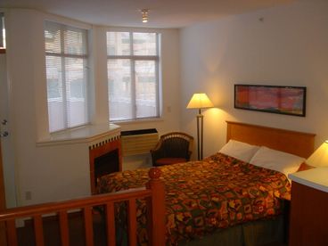 Queen bed and fireplace.