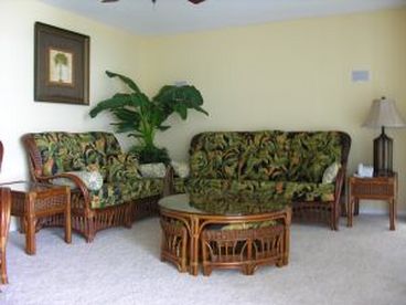 Family Room with window wall view of ocean and balcony access and ceiling fan.
