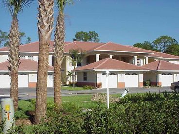 Exterior view of coach home - 2nd floor unit with garage parking.