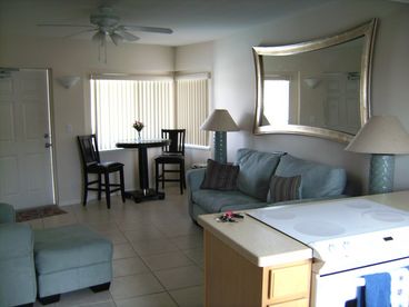 Beautifully decorated spacious living room, with cable tv, plenty of seating, tiled floors and sleeper sofa