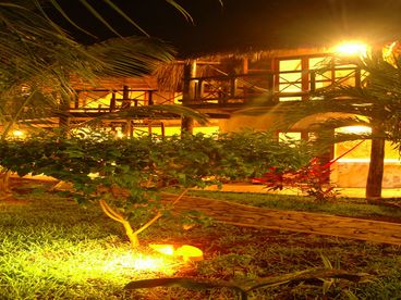 The rooms are surrounded by a lush garden with an outdoor grilling area