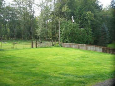 This property lies on a full half acre, from your front porch you see the harbor to your right and this grassy field and llama farm to your left.