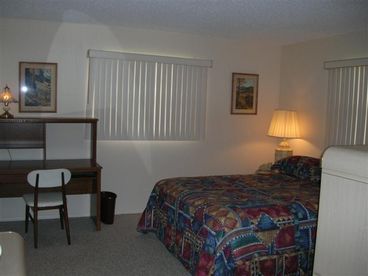 Master Bedroom with sliding glass door onto lanai overlooking water