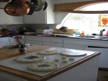 Four electric burners, two sinks, an electric oven, and a microwave