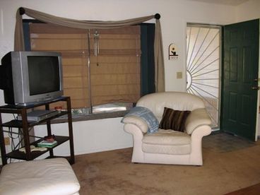 Living room with sliding glass door for access to backyard. Pet door insert is available upon request.