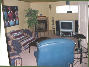 The livingroom has a fireplace., tv, and stereo.
