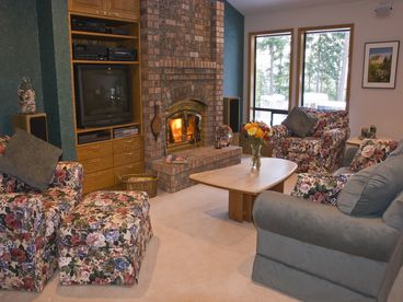 Large cozy family room with a toasty fireplace to warm you during the winter months.