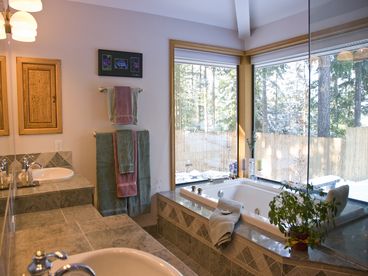 This master bathroom is a dream come true. Heated marble floors, jetted Jacuzzi tub, Steam shower, make up area overlooking a tranquil stream and pond.