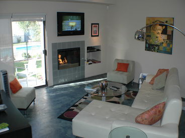 Sunken living room with contemporary polished concrete flooring, crushed glass gas fireplace, leather sofa, 42\