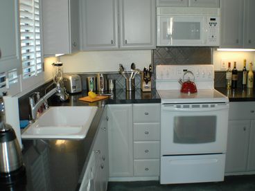 Gourmet kitchen with granite slab counters, all new appliances by GE & Bosch, top-of-the-line cookware & furnishings by Crate & Barrel and Williams Sonoma, kitchenette for 2...