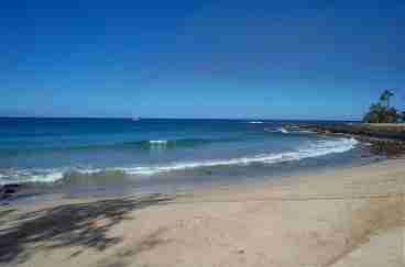 The sparkling blue Pacific Ocean is just 100 paces from the front door and this white sand beach is just four houses away.  Beyond this beach is Poipu Beach Park, rated #1 beach in America in 2001 by \