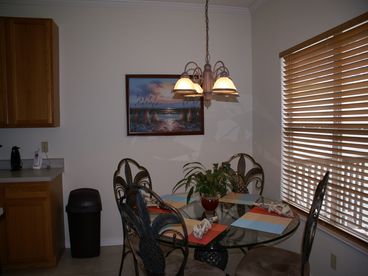 Seating for 4 at glass top dining table ~ open the blinds for a wonderful waterfront view!