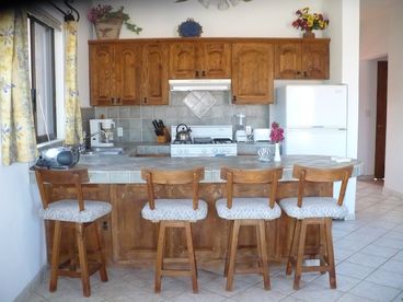 Kitchen has a microwave, coffee maker, bender, toaster, small cd player and all the dishes pots and pans silverware and cooking utensils