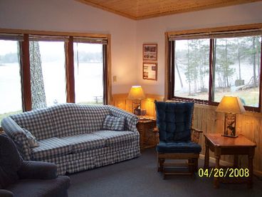 Cable television, DVD player, couch, chairs, and northwoods decor.  