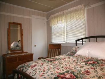 Furnished with prairie-period antiques this bedroom features a high quality matress on a full-size bed.  