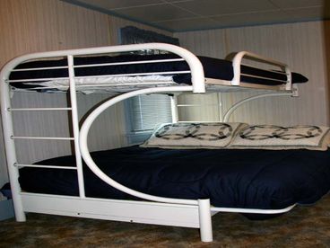The 2nd Bedroom features a Bunk-Bed with Twin on Top and Full on Bottom.  The room also has a writing desk with compliment greeting cards and envelopes as well as board games, puzzles, and a few toys for the younger children. 