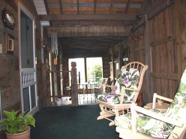 The Enclosed Patio area is off the Living Room.  It is spacious and comfy, perfect for family Bar-B-Qs and play.  There is a gas Bar-B-Q and dining table on the lower deck of the patio.  Smoking is allowed in this area. 