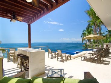 Spectacular covered bar and infinity pool with bar in the pool and hot tub.  Huge pool patio with plenty of room to enjoy the sun...