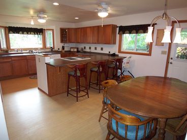 This huge kitchen is well stocked with pots, pans, dishes & utensils and complete with a dishwasher. 