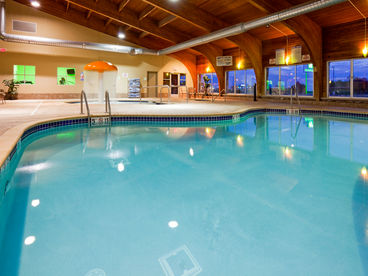Family friendly pool area with zero entry kiddie pool, whirlpool,  family swimming pool, arcade, fitness room, & sauna