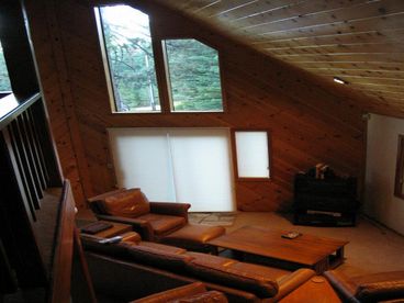 Birdseye view shows the pine cathedral ceilings and leather couches