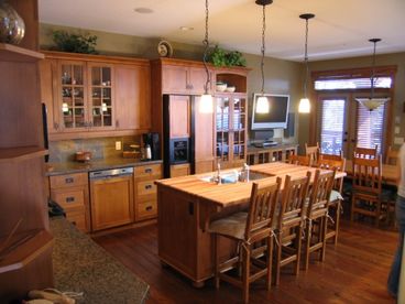 Gourmet kitchen with adjoining dining area and TV.  This area seats 12 for dinner incl. 4 at the kitchen island.