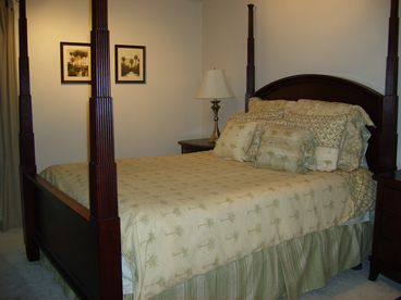 Master suite features queen poster bed, dressers, walk in closet.